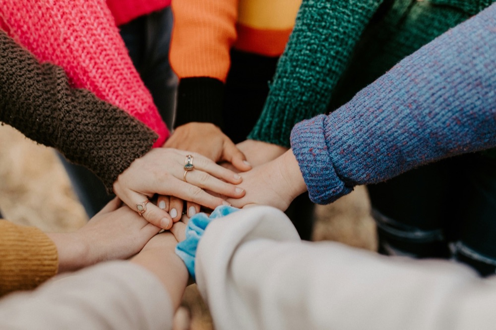 Hands joined together, representing collaborative care