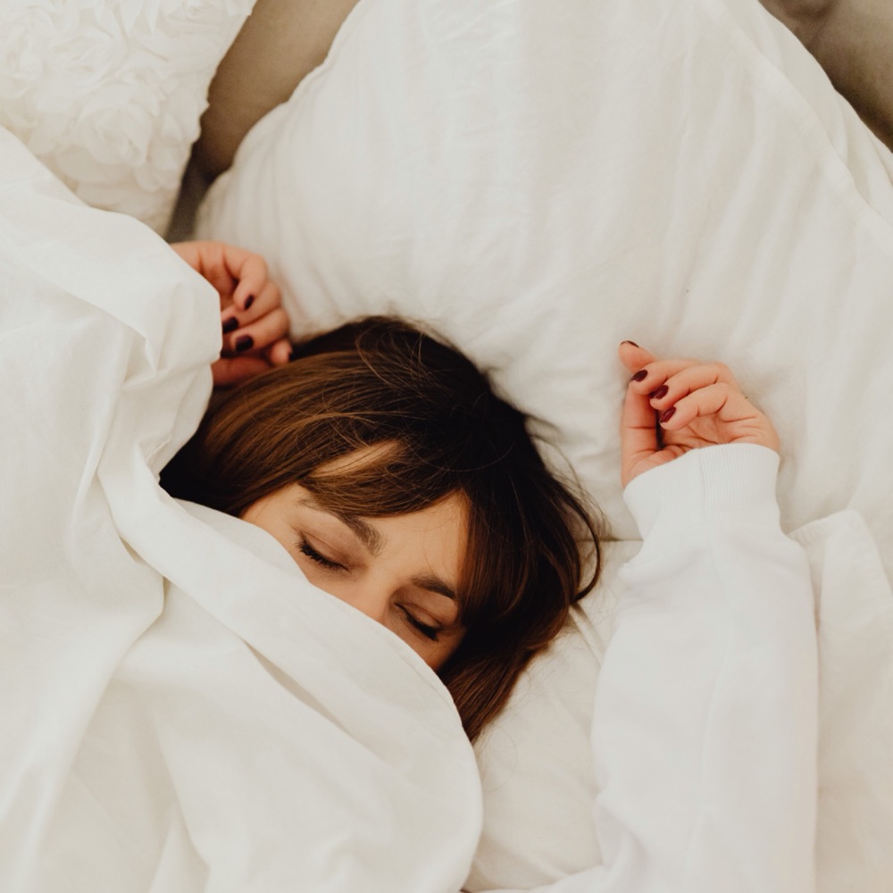 A person sleeping peacefully in a calm bedroom