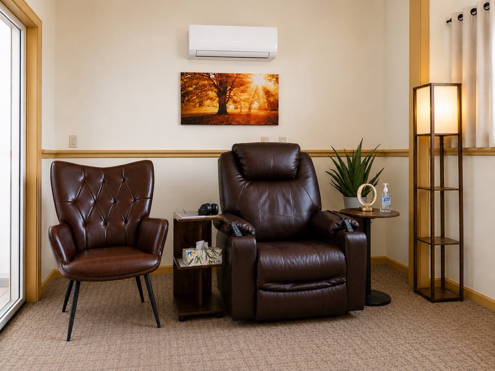 A Best Fit medication room with recliners, calming artwork, and a temperature control unit