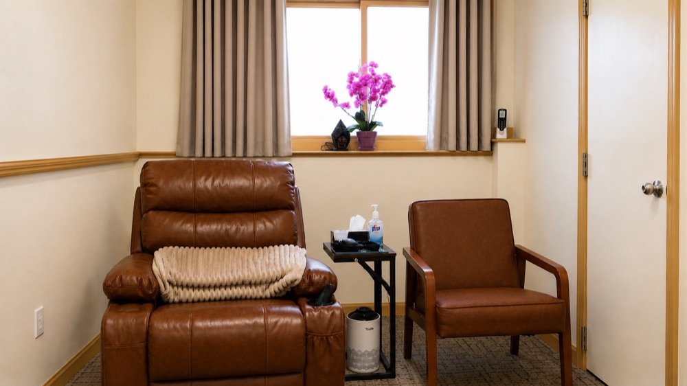 A Best Fit medication room with a leather recliner, side chair, and a window with natural light